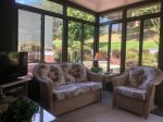 Sunroom with tv and seating area